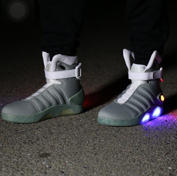 A pair of light up grey and white shoes.