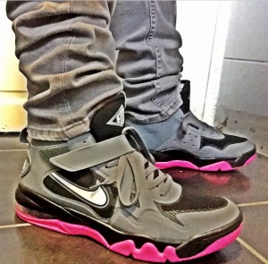 A pair of pink and grey Nike shoes.