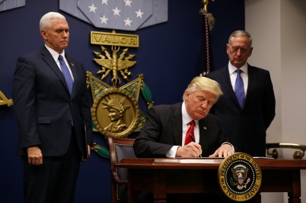 Trump signs revised travel ban order, leaves Iraq off