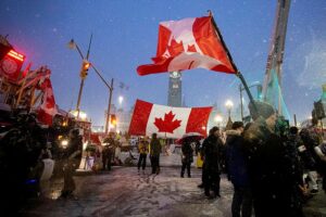 Protestors set up camp and fly Canadian flags outside of the country's parliament buildings in Ottawa.