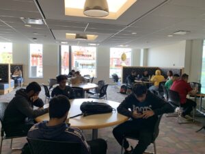 International students sitting in a round table in the cafeteria at the Lakeshore Campus.