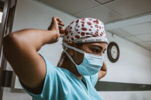 A nurse is being seen wearing a blue mask